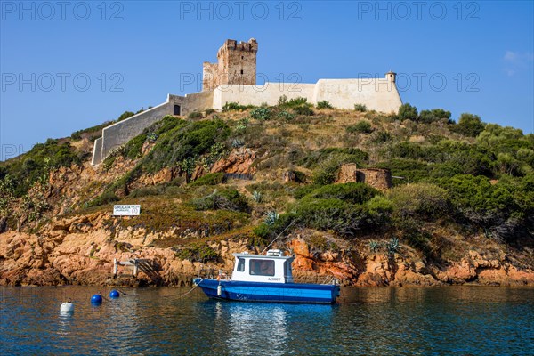 Genoese tower near the village of Girolata with staircase houses in the nature reserve of Scandola