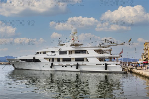 Luxury yacht with helicopter on deck anchored in the harbour of Saint Tropez