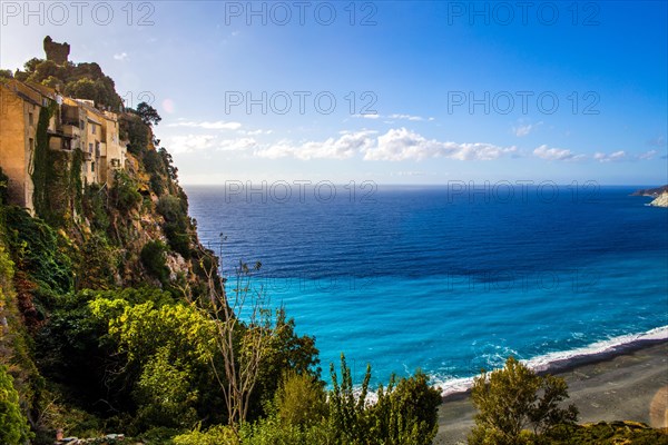 Nonza on the hillside with black beach