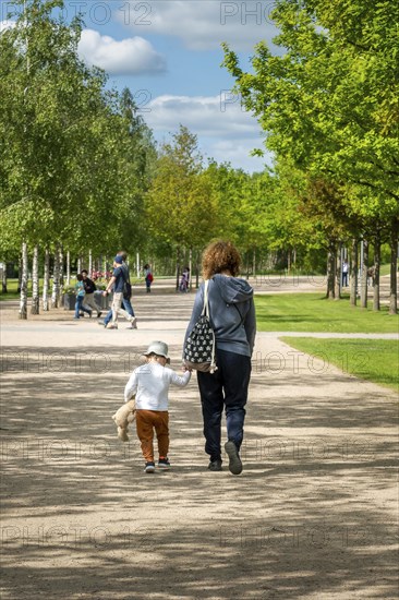 Grandma and grandson walking in the municipal park