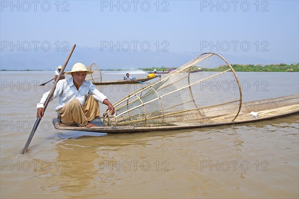 Fishermen with fish trap and nets