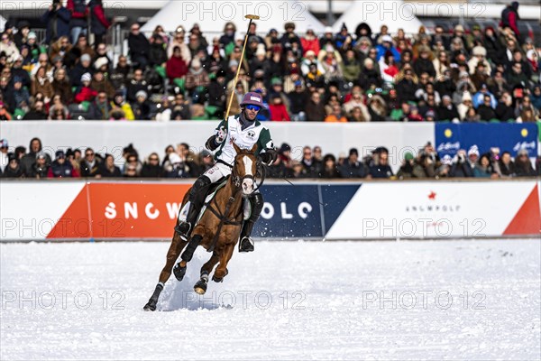 Spectators watch from the bleachers as Agustin Kronhaus of Team Azerbaijan Land of Fire gallops across the field