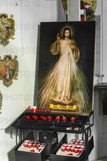 Image of Jesus with sacrificial candles