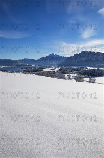 View of snow-covered Mondseeland with Schafberg and Drachenwand