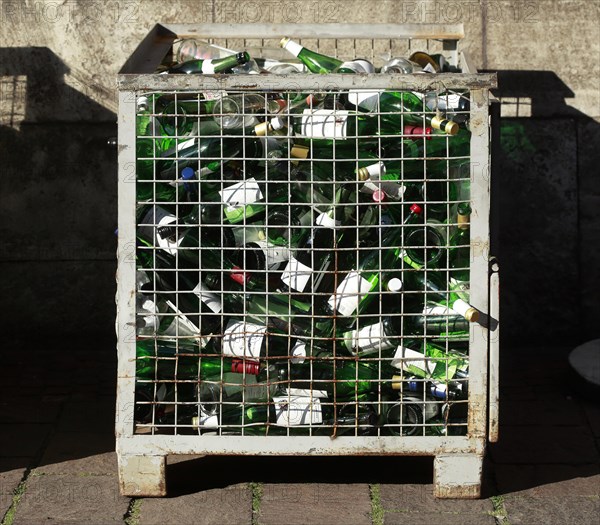 Empty wine bottles in a waste glass container