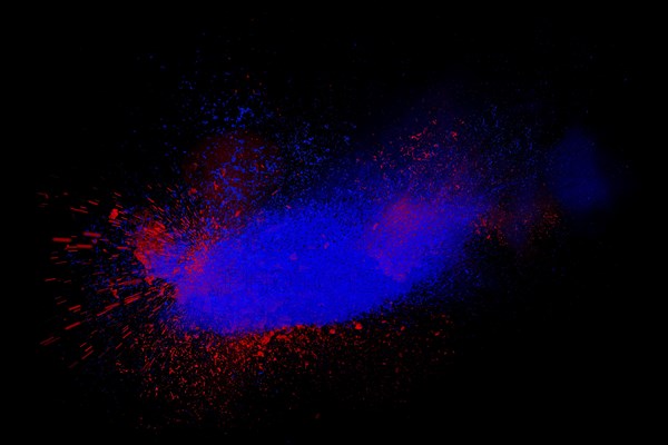 Freeze motion of red and blue powder exploding