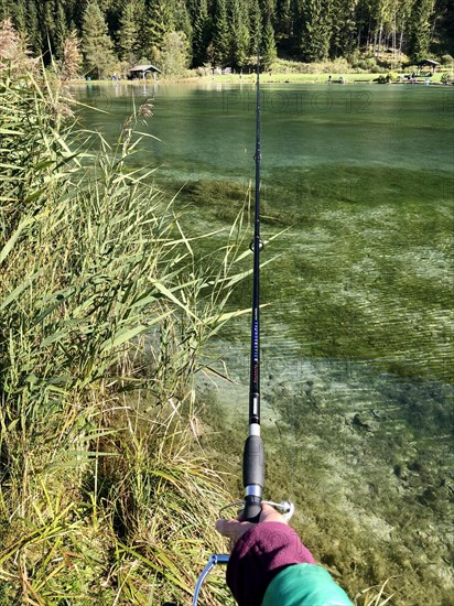 Hand holding fishing rod