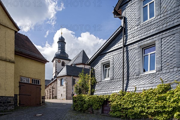 St. James Catholic Church among old clapboard houses made of wood and slate