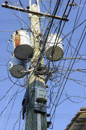 Tangle of knotted power cables on power distribution pole