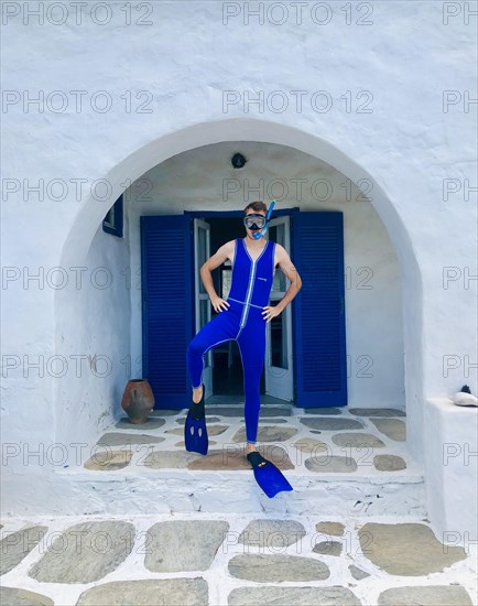 Young man in blue wetsuit with fins