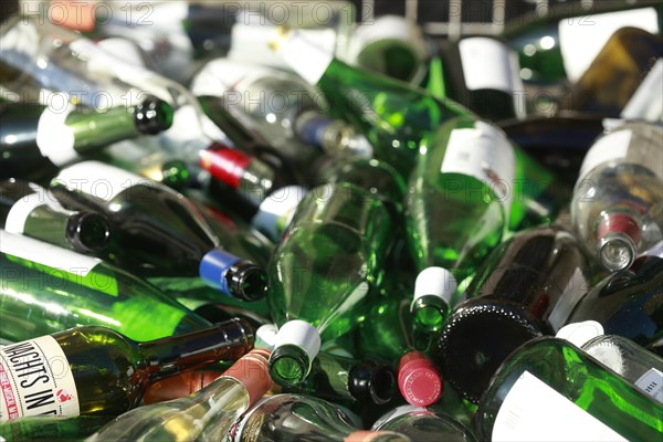 Empty wine bottles in a waste glass container