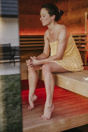 Man with infusion tub in sauna