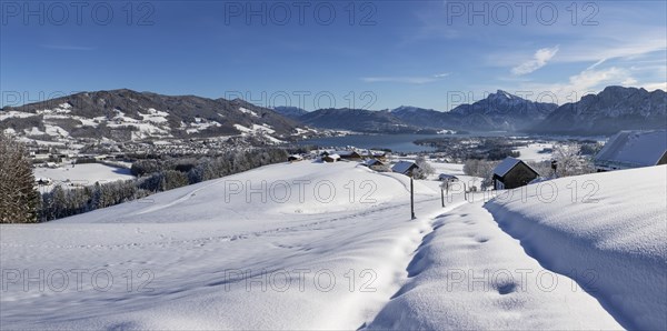 View of snow-covered Mondseeland with Schafberg and Drachenwand