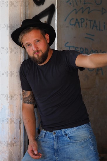 Young man with beard and black hat