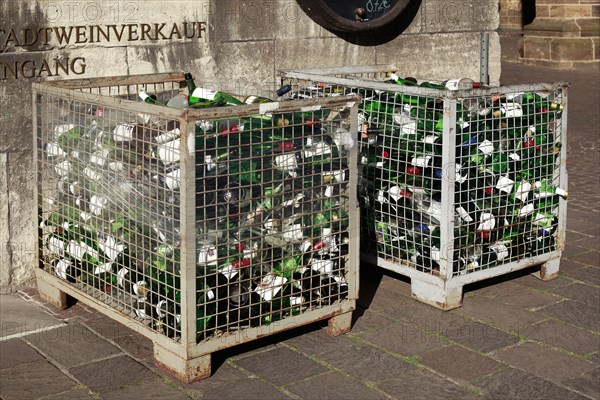 Empty wine bottles in a waste glass container