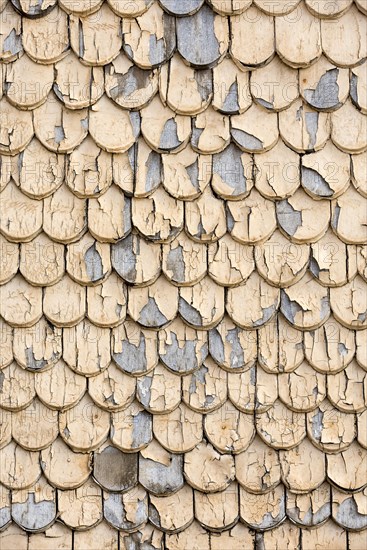 pattern of old wooden shingles with peeling paint