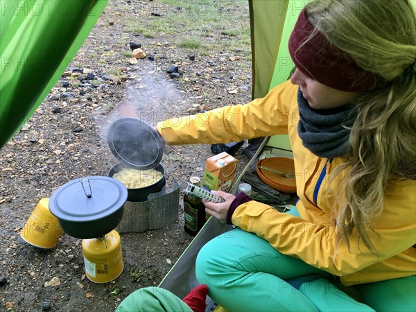 Young woman sitting in a tent