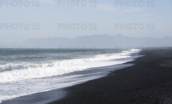 Black sandy beach by the sea