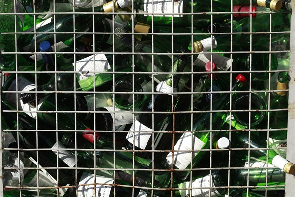 Empty wine bottles in a waste glass container