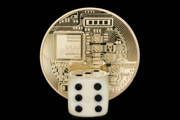 A dice in front of a coin