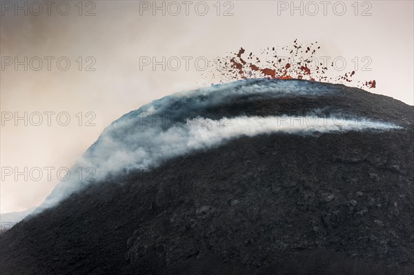 Glowing lava spurting from crater