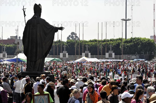 Monument to Pope John Paul II with faithful