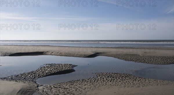 Sandy beach beach at low tide with tide pools