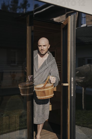 Man with infusion tub in sauna