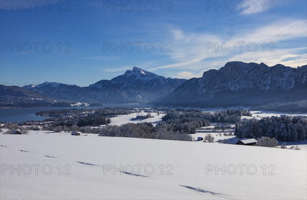 View of snow-covered Mondseeland with Schafberg and Drachenwand