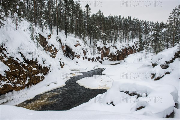 Snowy winter landscape with river course in Oulanka National Park