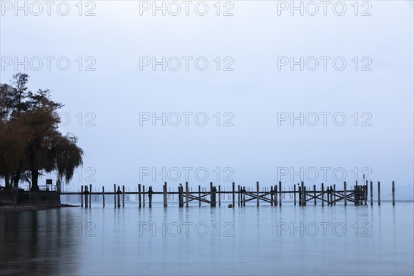 Empty shipping pier in autumn rain