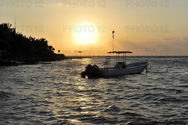 Sunset with boat at Playa del Carmen