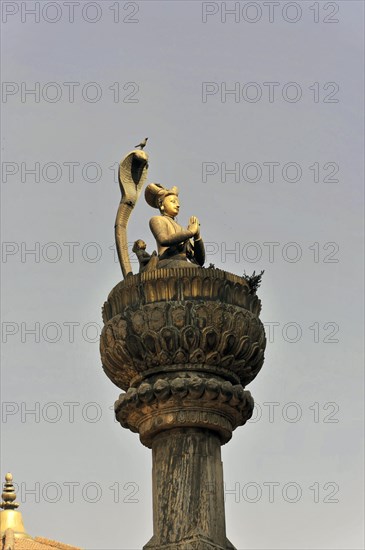 Statue of King Yoganarendra Malla with snake and bird