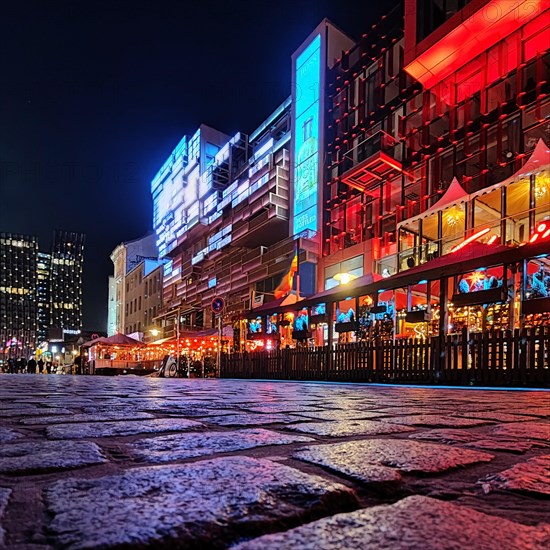 Night illumination at Spielbudenplatz with the Schmidt Theatre and the Dancing Towers in the background