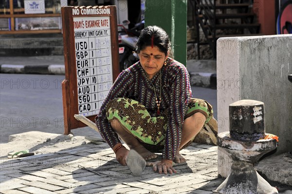 Nepalese woman repairing the road
