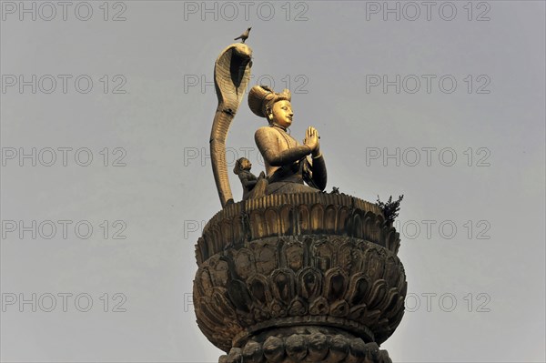 Statue of King Yoganarendra Malla with snake and bird