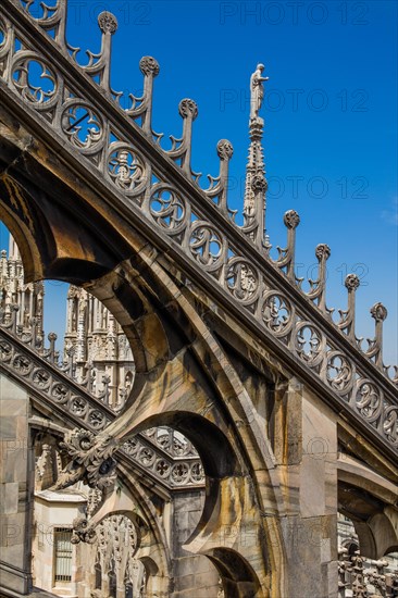 Stone carving on the roof of Milan Cathedral in white marble