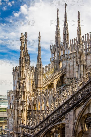 Stone carving on the roof of Milan Cathedral in white marble