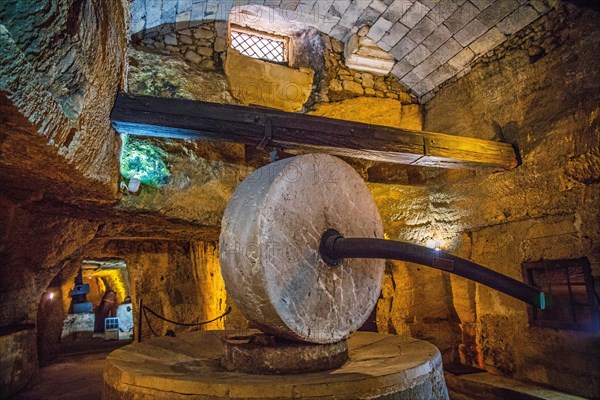 Underground oil mill with millstones