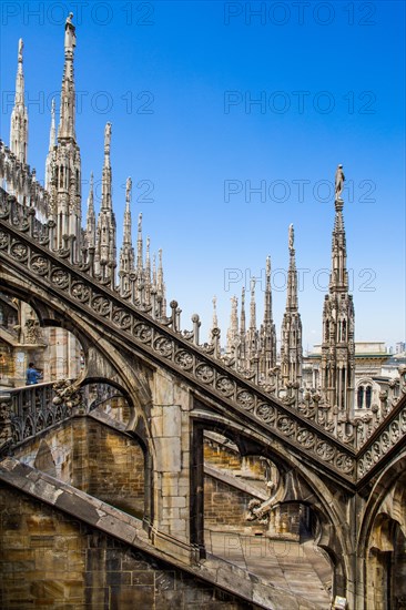 Stone carving on the roof of Milan Cathedral in white marble