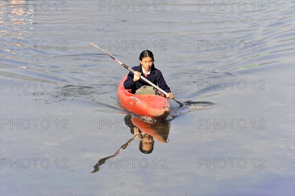 Schoolgirl with paddle boat