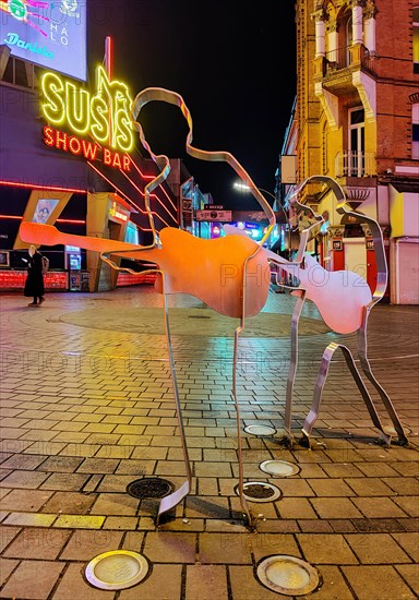 Beatles metal figures on Beatles Square at night