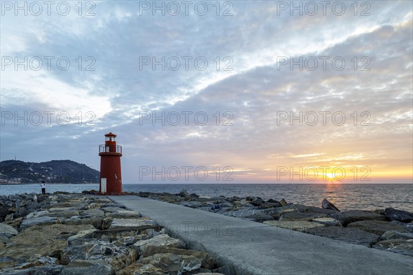 Sunrise with lighthouse at the harbour pier in Porto Maurizio