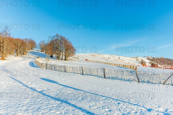 Cross-country ski trail in the snowy mountain on a sunny day. France