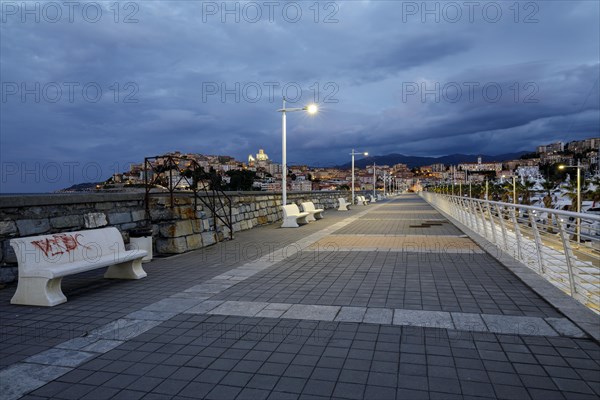 Sunrise with lighthouse at the harbour pier in Porto Maurizio