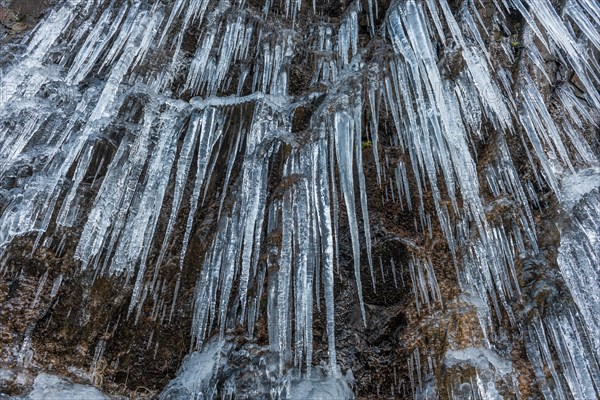 Icicles forming an icefall in the mountain in winter. France