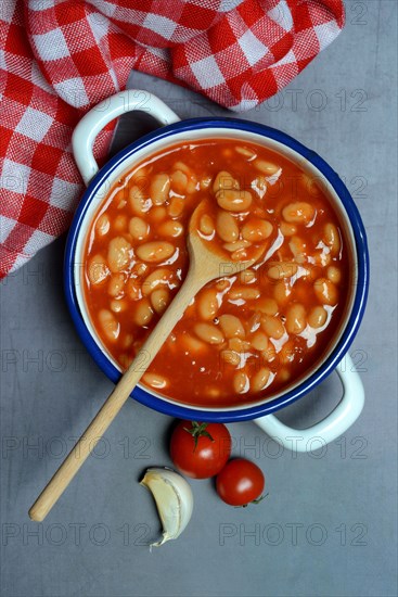 White beans with tomato sauce in pot