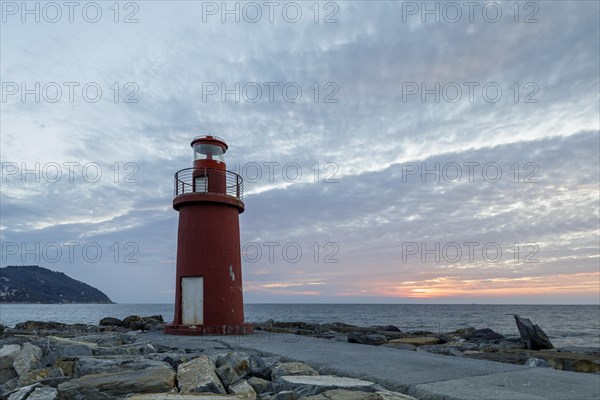 Sunrise with lighthouse at the harbour pier in Porto Maurizio