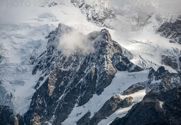 Cloud-covered mountain with snow and glacier