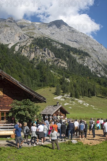 Mass celebration on Almkirtag in front of the wooden chapel in the mountain village of Eng